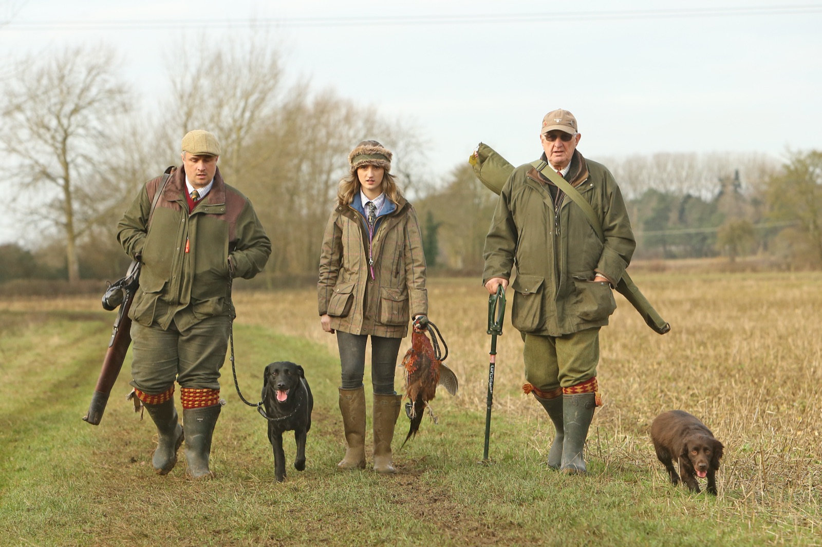 Three guns and their dogs walk in from the drive